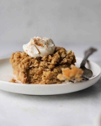 A slice of pear coffee cake on a white plate.