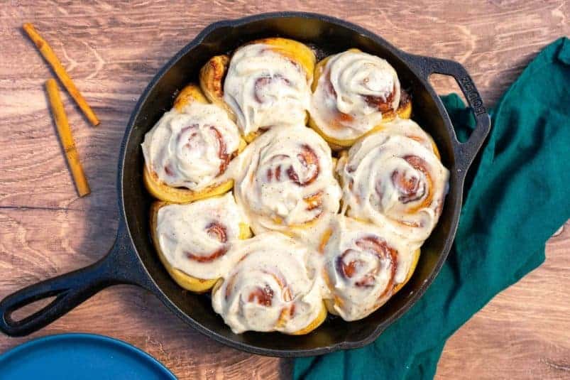 Sourdough Cinnamon Rolls with Cream Cheese Frosting in a Cast Iron Skillet.