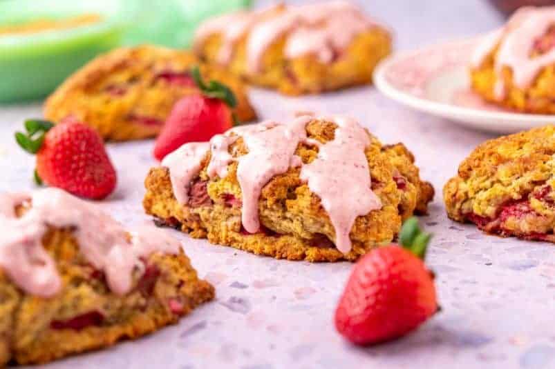 Sourdough strawberry scones with strawberry glaze and fresh strawberries.