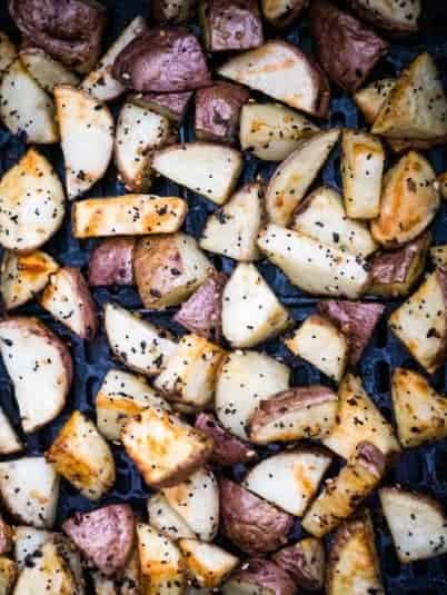 Air fryer cod fillets without breading topped with lemon and herbs.