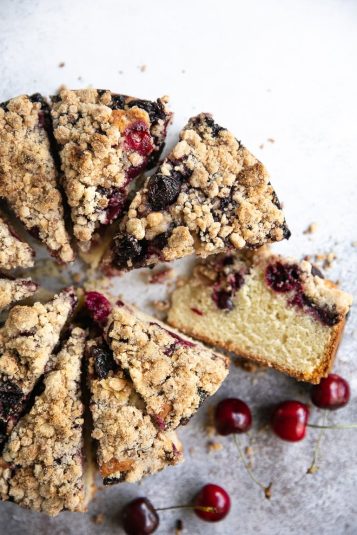 Overhead shot of a sliced cherry cake with crumb topping.