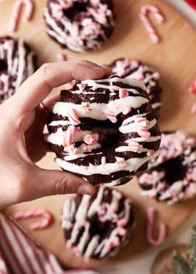 A hand holding a Chocolate Peppermint Mini Bundt Cake.