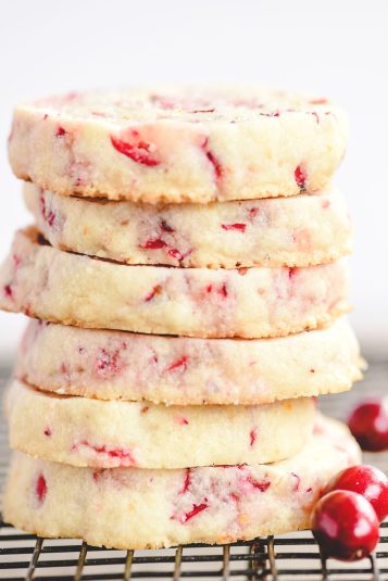 A stack of cranberry orange shortbread cookies.