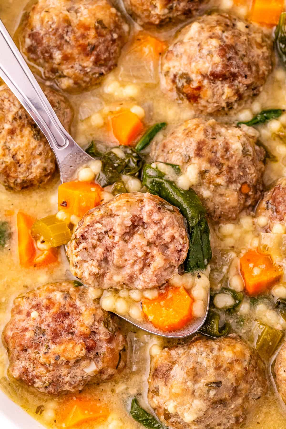 Savory meatballs in creamy vegetable gravy served in a bowl with carrots and spinach. Perfect comfort food recipe.