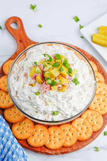 Creamy ham and cheese dip with crackers, perfect for game day appetizers.