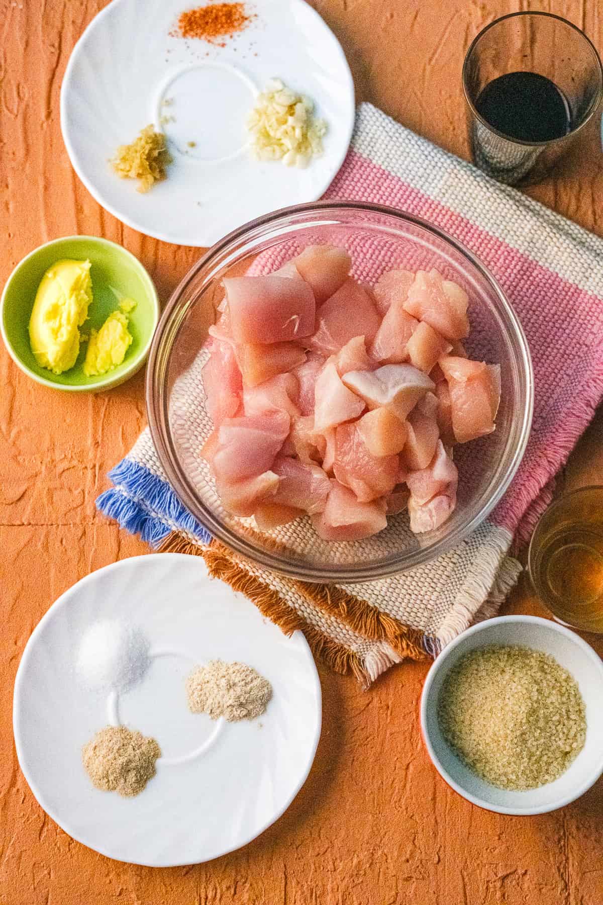 ingredients including chicken thighs, soy sauce, garlic, ginger, salt, and butter.
