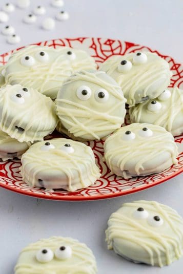 Orange pretzel bark with pretzels on a marble countertop.
