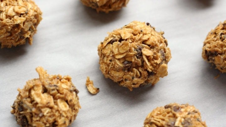 Chocolate coated peanut butter ball on parchment paper.