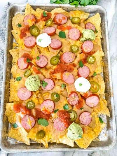 A full baking sheet full of Sausage Beer Cheese Nachos.