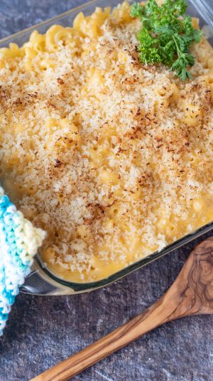 Spoon scooping out golden brown mac and cheese.