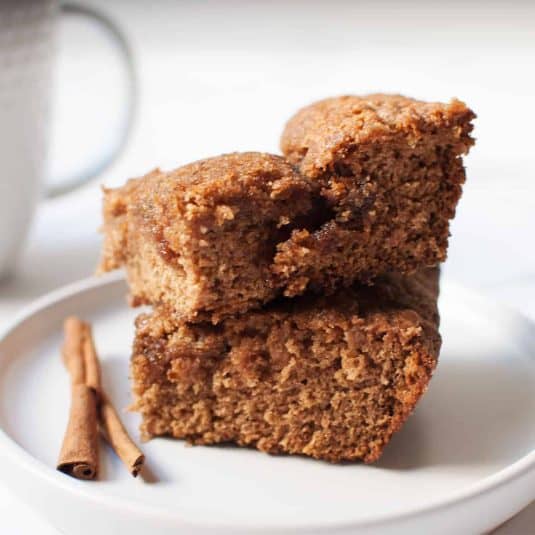 Sourdough Discard Coffee Cake slices on a plate with cinnamon sticks.