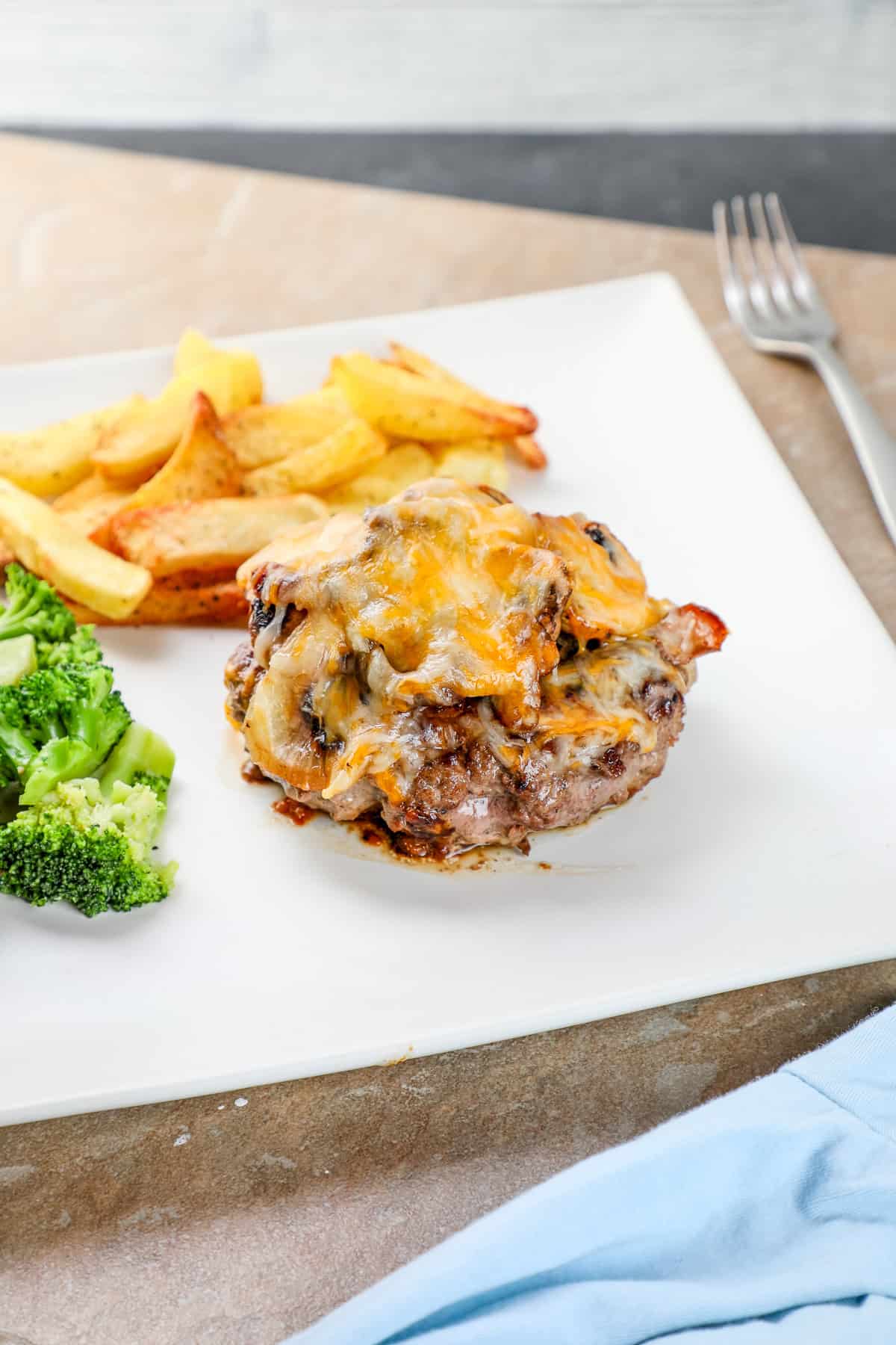 texas roadhouse roadkill chopped steak topped with onions, mushrooms, and cheese served with fries.