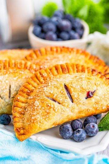 Golden brown Hand Pies on a white plate.