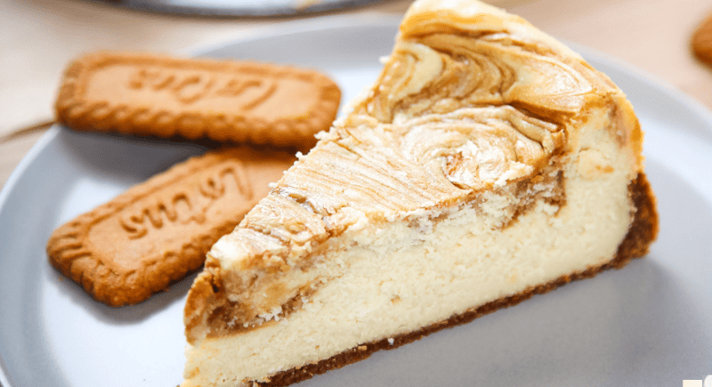 biscoff cheesecake on a plate with Lotus biscoff cookies.
