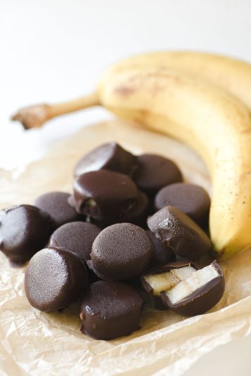 Chocolate covered frozen banana bites, with bananas.