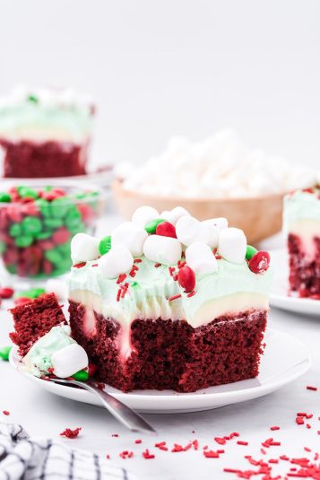 Christmas Red Velvet Poke Cake on a white plate.