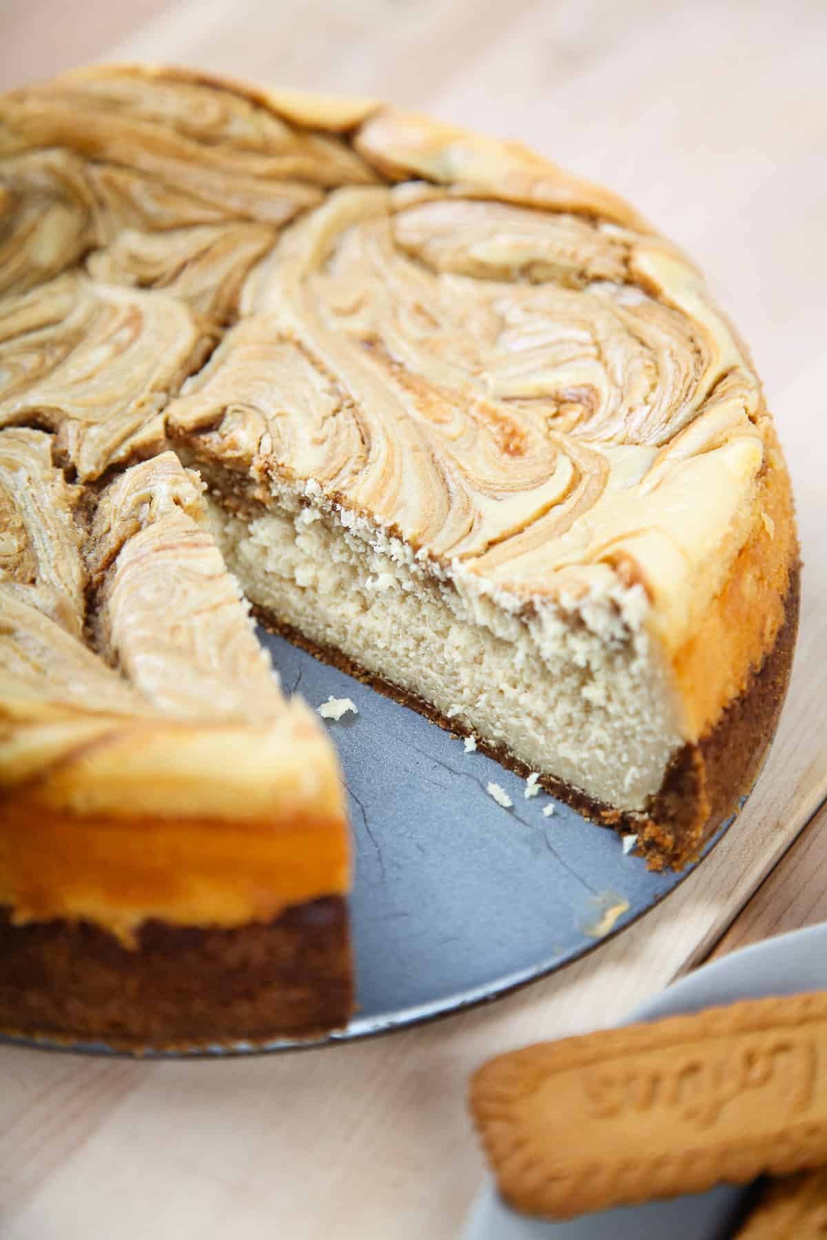 a biscoff cheesecake with a cookie butter swirl in a springform pan.