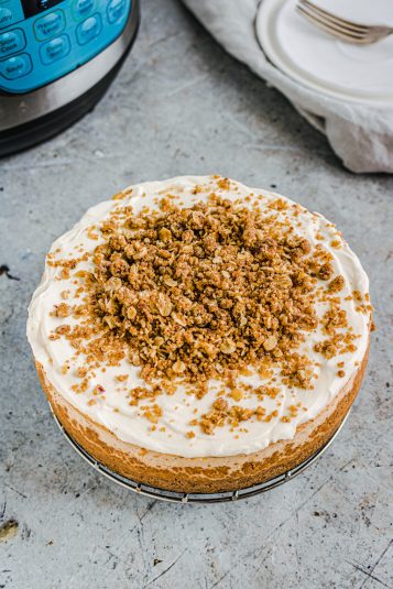 Top down view of the completed cheescake sitting in front of the Instant Pot.