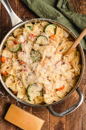 Skillet of Italian Seasoning Pasta with freshly shredded Parmesan cheese on top.