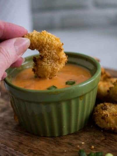 Slow Cooker Turkey Breast on a plate with gravy, stuffing, mashed potatoes and a roll.