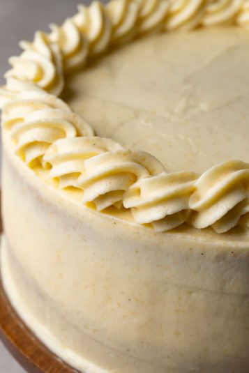 Creamy vanilla frosting piped along the edge of a delicious cake for a perfect dessert presentation.
