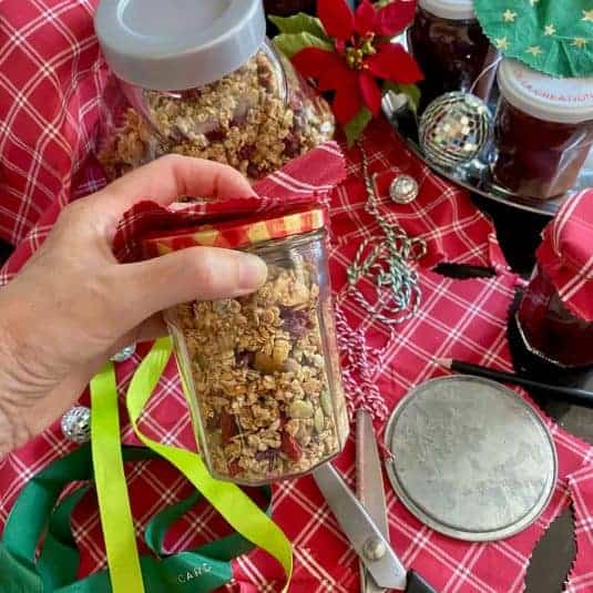 Preparing jars of homemade granola for Christmas presents.
