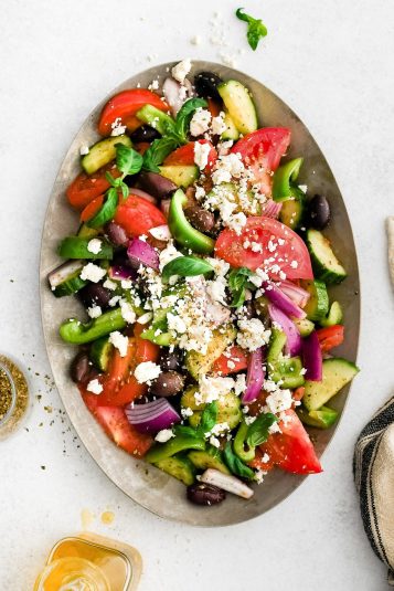 Fresh Greek salad with tomatoes, cucumbers, olives, feta cheese, and herbs. Perfect for healthy, easy-to-make recipes.