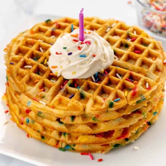 Soft Funfetti Waffles with Whipped Cream and Colorful Sprinkles - Perfect Birthday Breakfast.