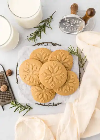 Nutmeg cookies resting on a cooling rack.