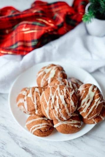 Chocolate eggnog drop cookies on a white plate with a plaid napkin.