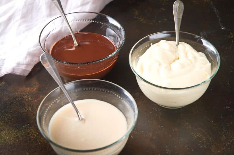 Assorted bowl of chocolates, yogurt, and cream for baking and dessert recipes.