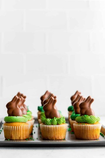 Carrot cake cupcakes with bunnies on top.