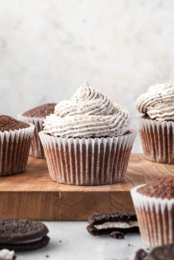 Cream cheese Oreo frosting cupcakes on baking tray, decorated with Oreo cookies, perfect for dessert.