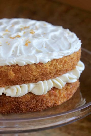 Creamy coconut cake with whipped frosting and toasted coconut flakes.