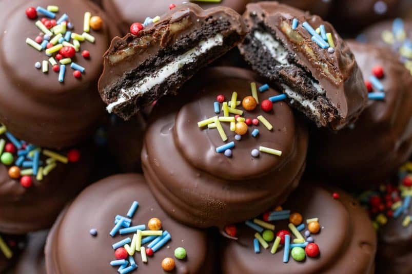 A pile of chocolate covered Oreo cookies.