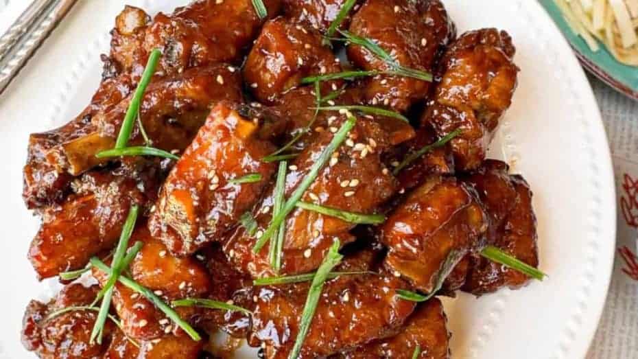 Baked tender, sticky, and savory Asian chicken wings on a plate.