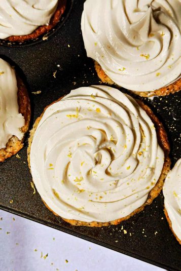 Buttery lemon meringue tartlets topped with whipped cream and lemon zest. Perfect for dessert or tea time.