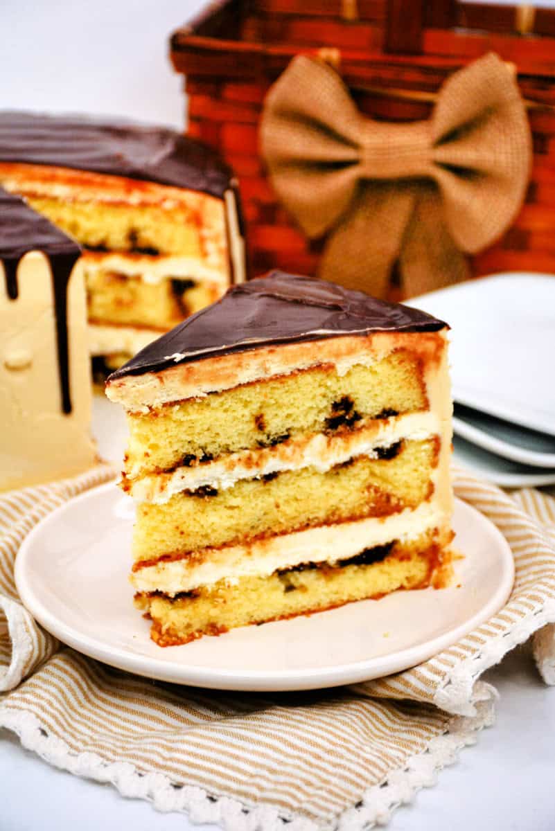 a slice of a 3 layer vanilla cake with a Bailey's espresso syrup, coffee buttercream, and mocha ganache.