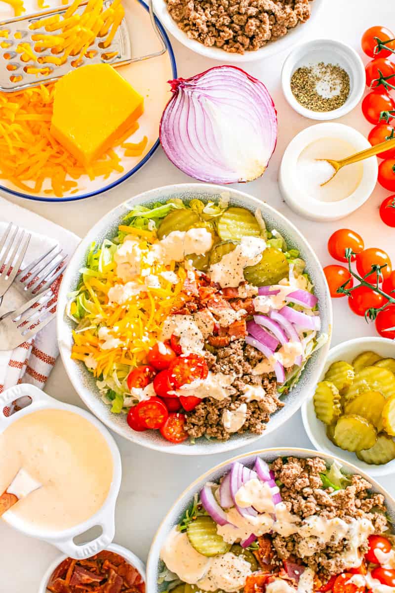 a big mac bowl with lettuce, tomatoes, cheese, pickles, onion, bacon, and homemade mac sauce.