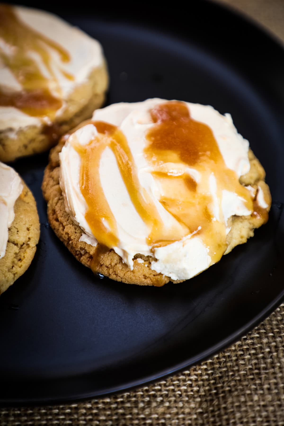 a butterbeer cookie frosted with buttercream and drizzle with butterbeer caramel sauce.
