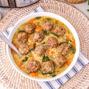 Savory meatball soup with vegetables in a creamy broth, perfect for cozy family dinners.