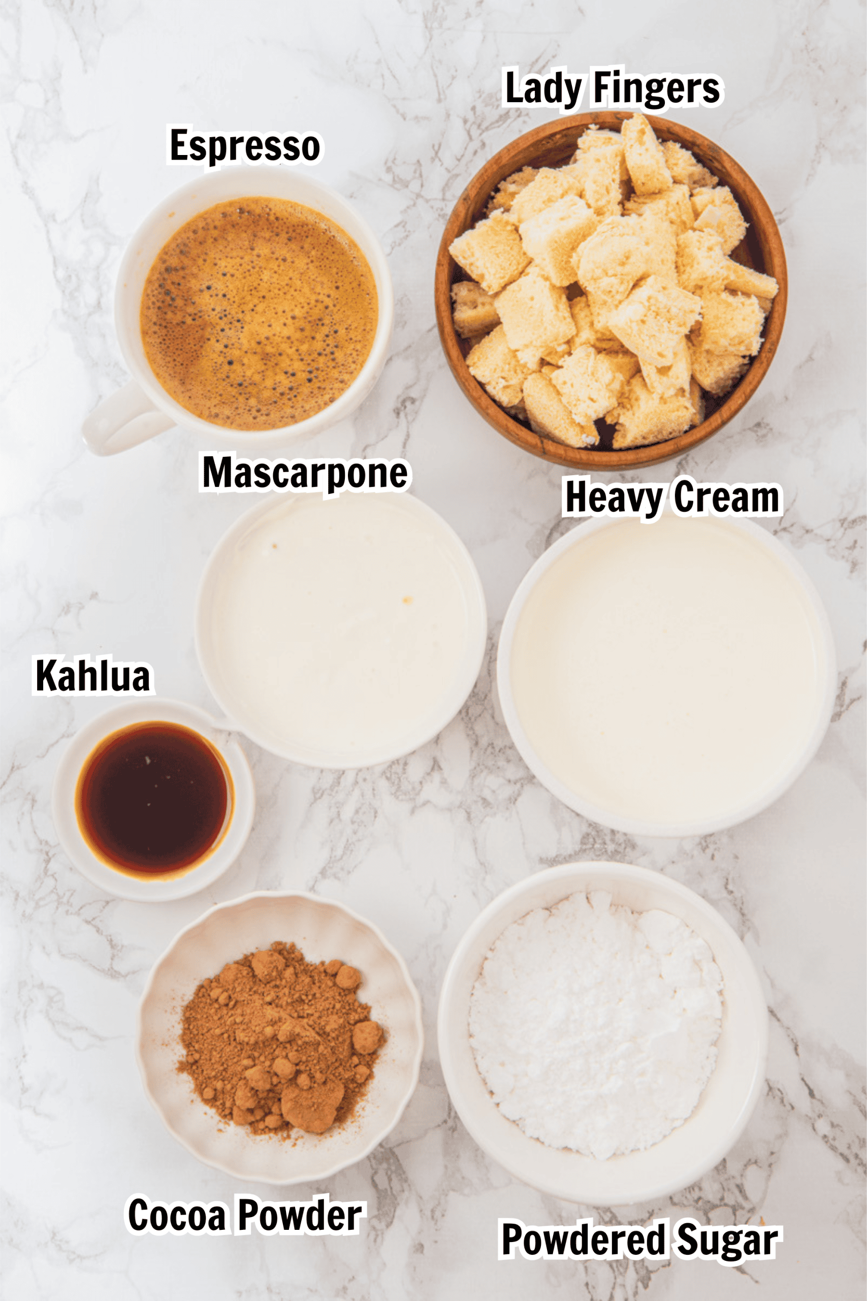 ingredients including ladyfingers, mascarpone, espresso, Kahlua, cocoa powdered, heavy cream, and powdered sugar.