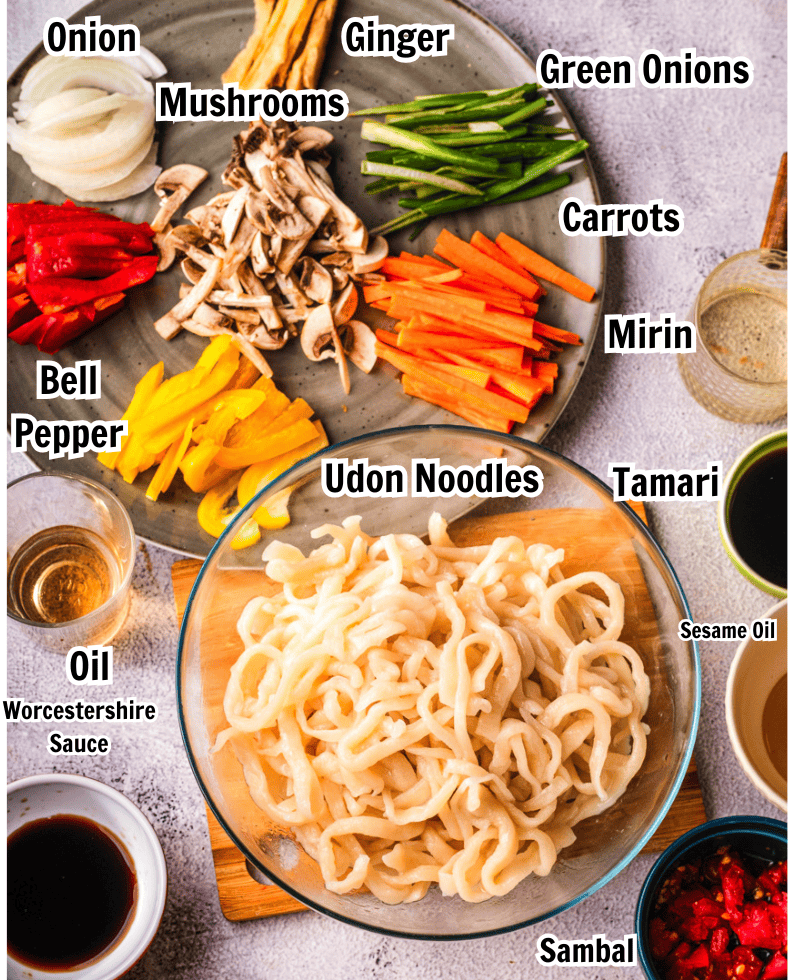 ingredients including udon noodles, mushrooms, bell pepper, carrots, onion, mirin, tamari, Worcestershire sauce, and sambal. 