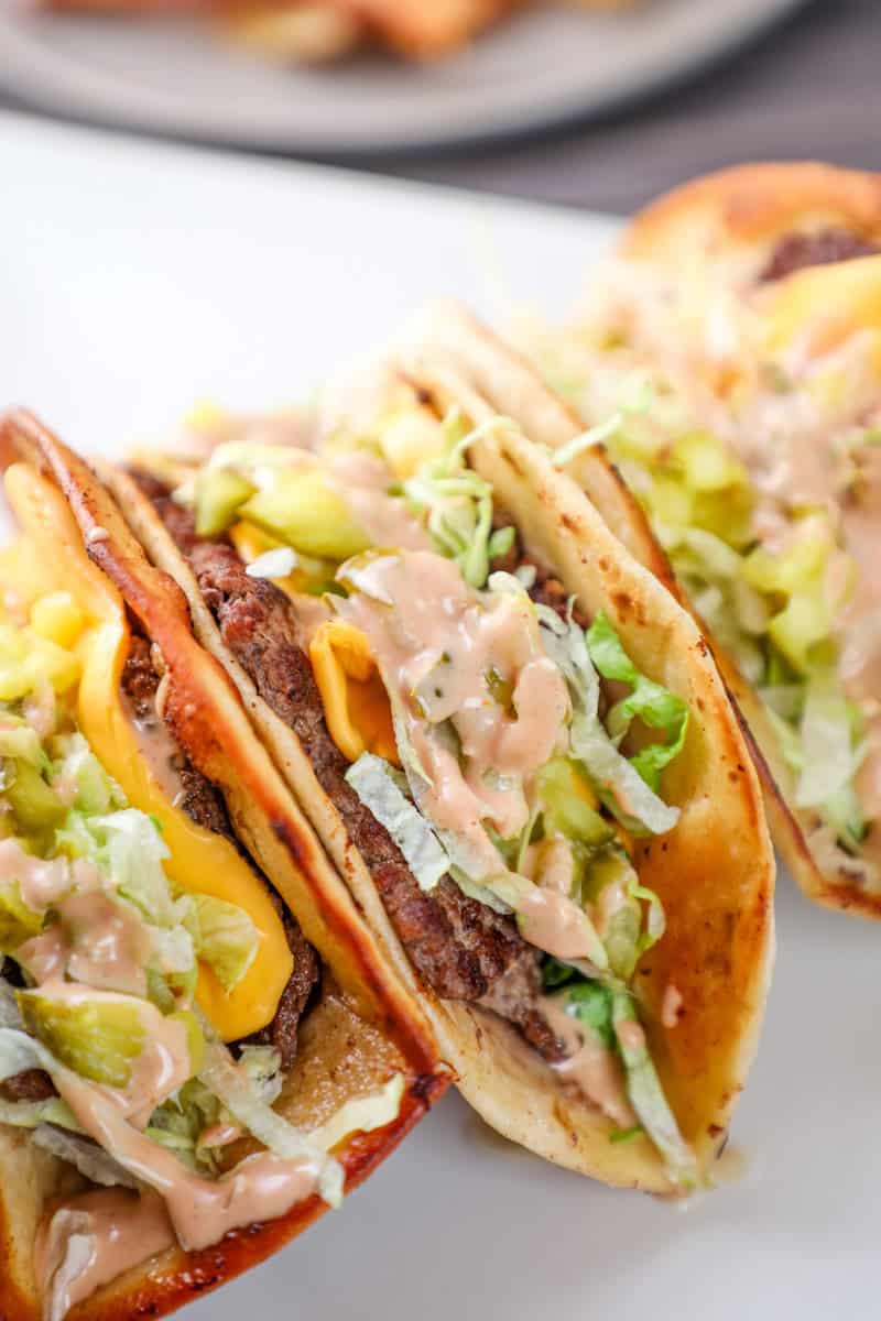 a smash burger taco topped with American cheese, shredded lettuce, and big mac sauce. 