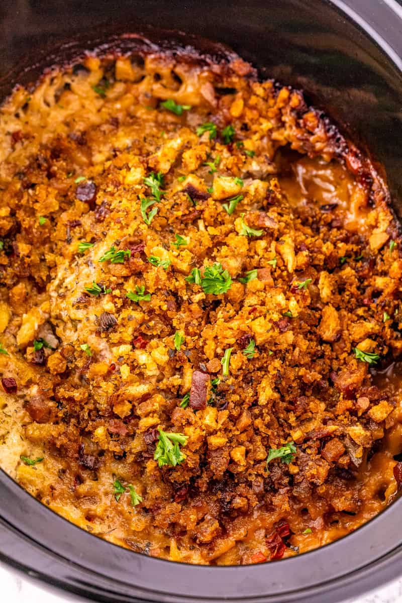 pork chops and stuffing in a black crock pot.