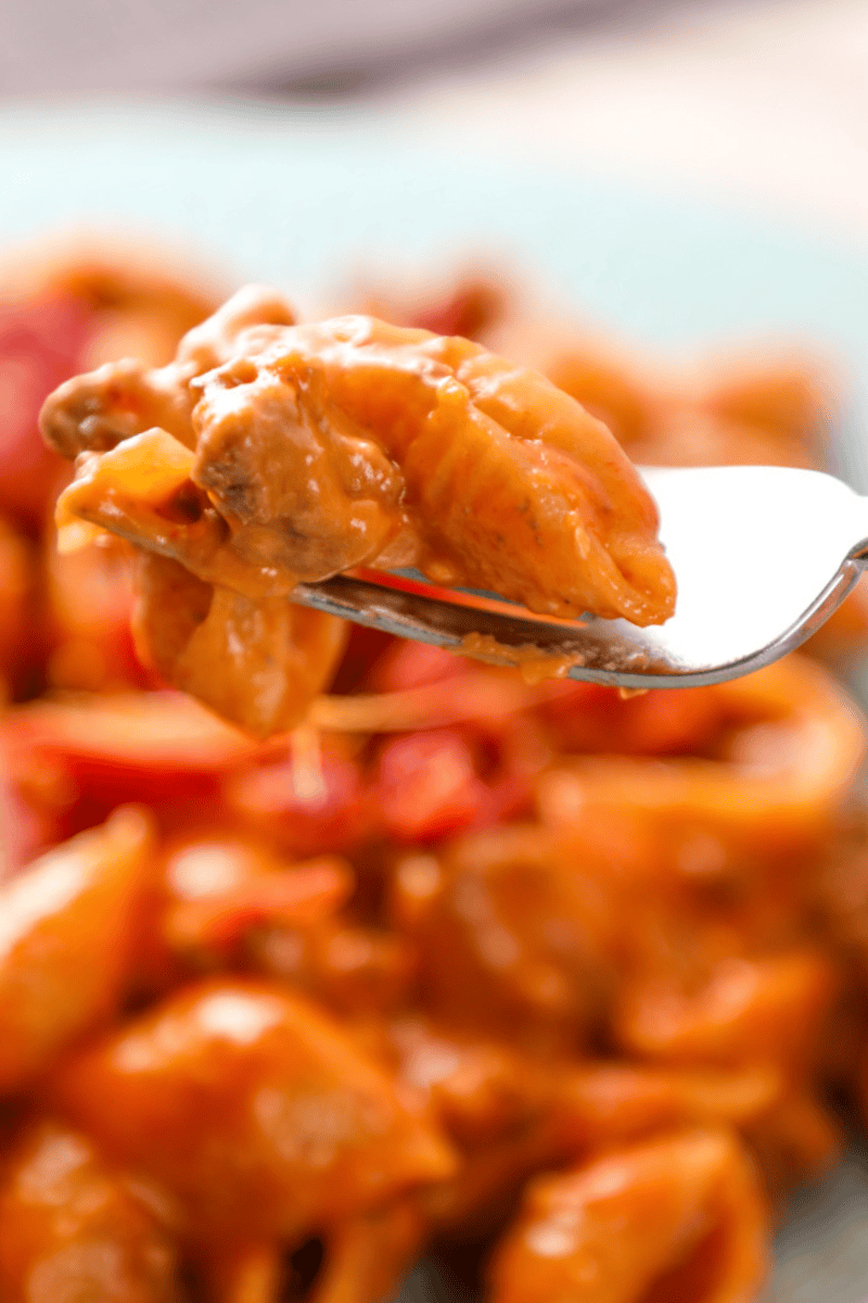 a fork with bacon cheeseburger pasta with round beef, a creamy sauce, and cheese. 