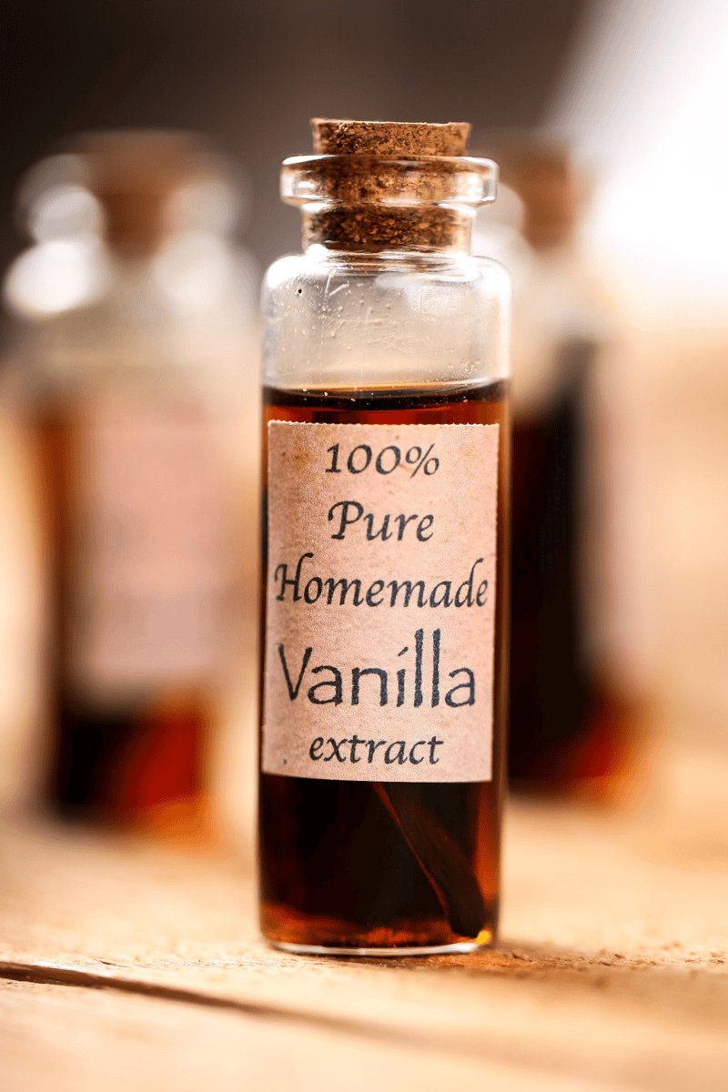 a glass container of homemade vanilla extract with a cork stopper.