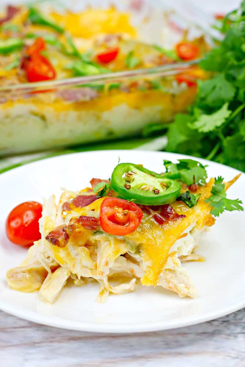 chicken jalapeno casserole topped with a jalapeno slice, cherry tomatoes, and cilantro.