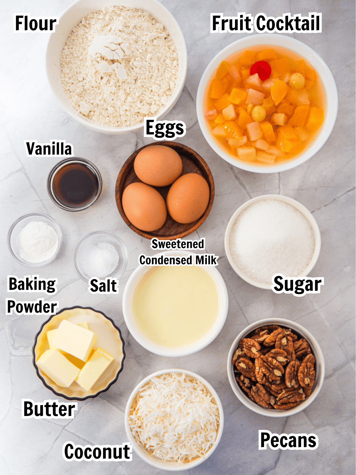 ingredients including flour, fruit cocktail butter, eggs, vanilla, sugar, sweetened condensed milk, pecans, and coconut.