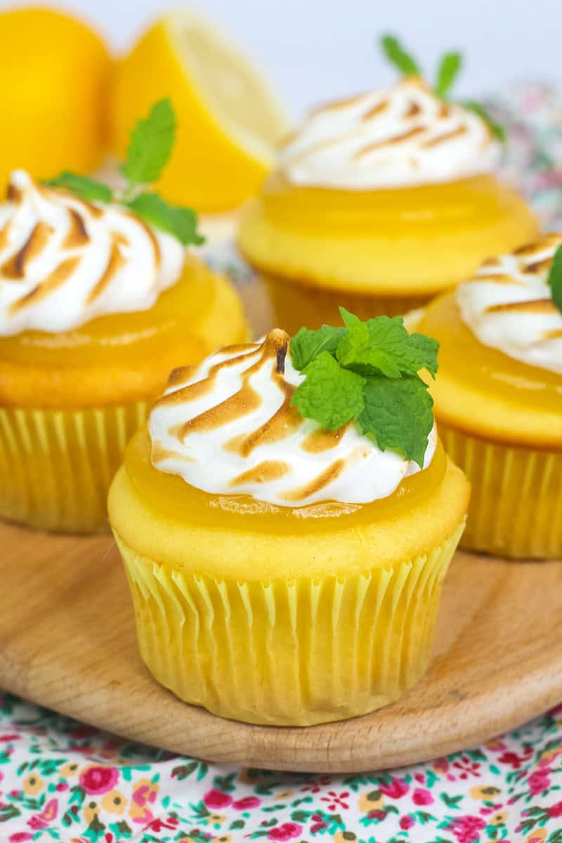 lemon meringue cupcakes topped with lemon curd, toasted meringue and fresh  mint.